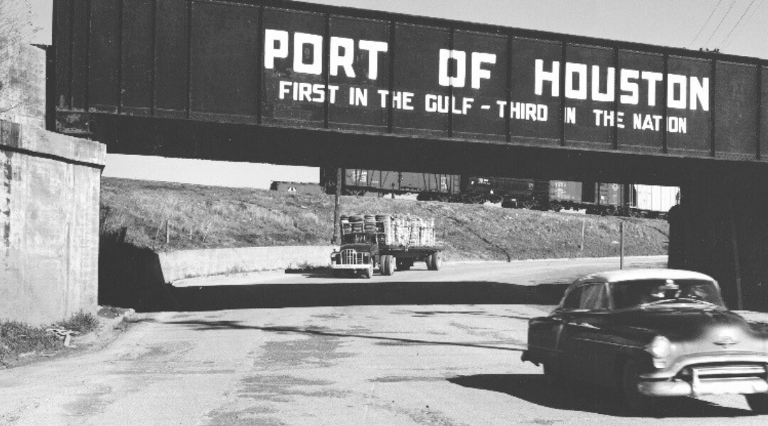 Car going under bridge where container shows 